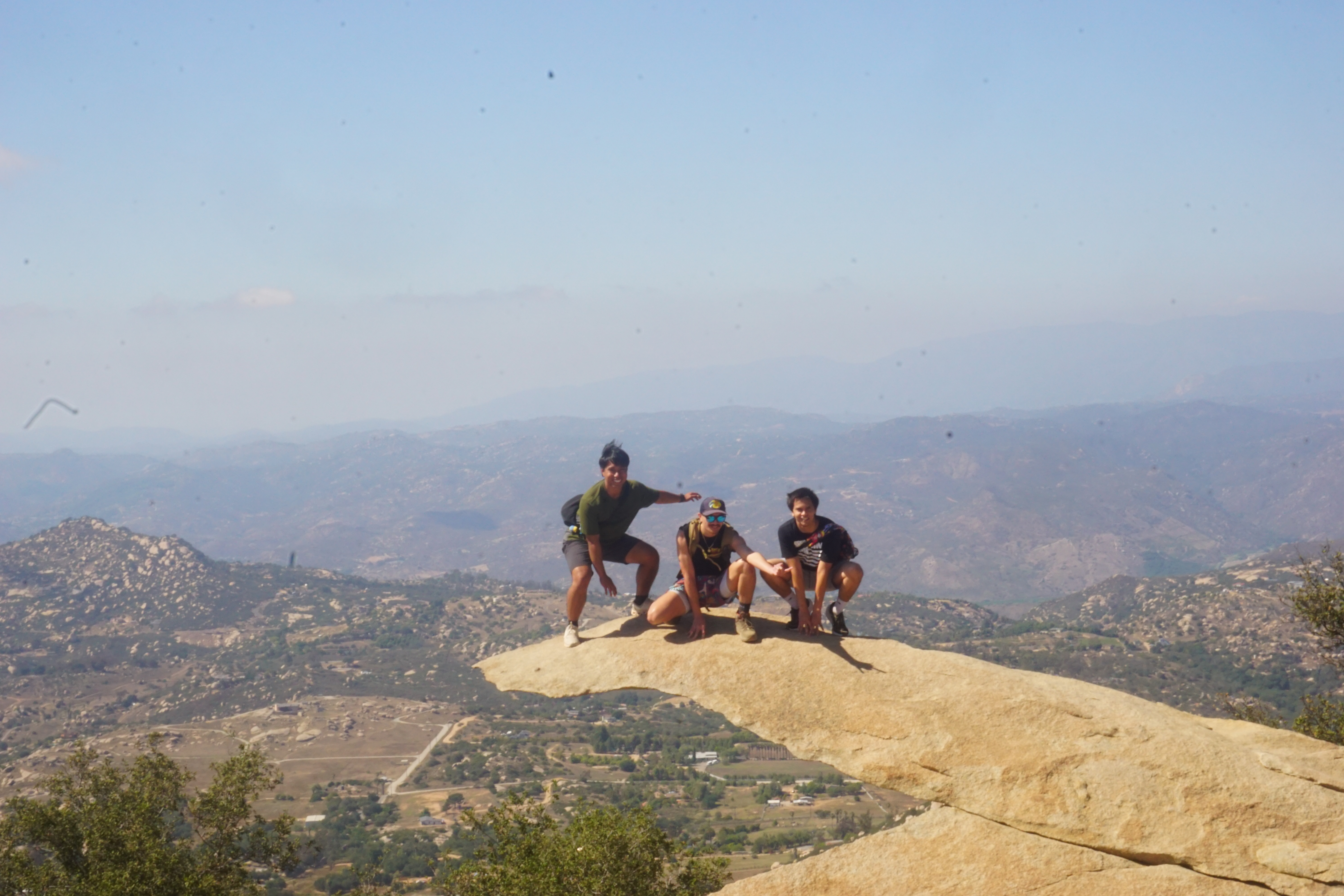 Group of three posing on Potato Chip Rock